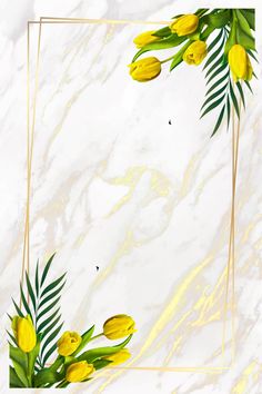 yellow tulips and palm leaves in a gold frame on a white marble background