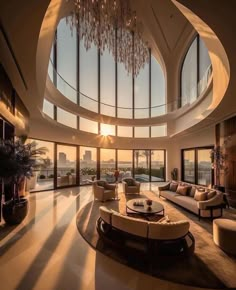 a large living room with high ceilings and floor to ceiling windows