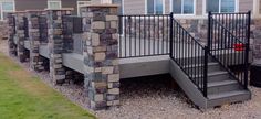 a house with stone walls and metal railings