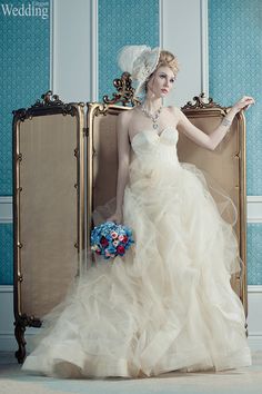 a woman in a wedding dress sitting on a suitcase