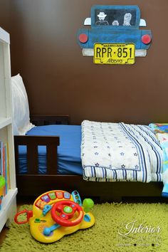 a child's bedroom with a toy car on the wall