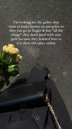 a woman's hand holding a yellow rose in front of a quote on the wall