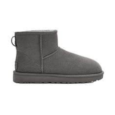 Ugg Women's Classic Mini II Boot Our Classic boot was originally worn by surfers to keep warm after early-morning sessions, and has since become iconic for its soft sheepskin and enduring design. Incorporating a durable, lightweight sole to increase cushioning and traction, these versatile boots pair well with practically anything – try loose boyfriend jeans and a velvet top. This product was made in a factory that supports women in our supply chain with the help of HERproject, a collaborative i How To Wear Uggs, Classic Mini Ii Boot, Ugg Grey, Grey Ugg, Grey Ugg Boots, Ugg Classic Mini Ii, Ugg Store, Ugg Tasman Slippers, Classic Ugg Boots