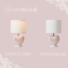 two pink lamps with white shades on them