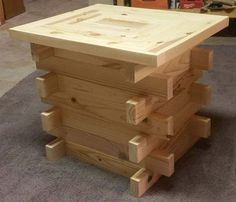 a table made out of wooden pallets in a room with carpeted flooring