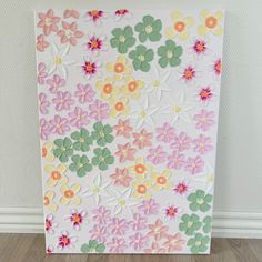 a painting made out of paper with flowers on it