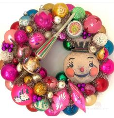 a christmas ornament wreath with ornaments around it