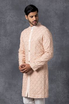 Peach sherwani with embroidered floral motifs. Comes with churidar.
Components: 2
Fabric: Pure georgette
Neckline: Band collar
Sleeve Length: Full
Color: Peach
Embroidery
Lining material: Cotton
Lucknowi embroidery
Closure: Front button placket on sherwani
Note: Inner kurta worn by model is not for sale. - Aza Fashions Diwali Anarkali Sherwani With Chikankari Embroidery, Peach Kurta With Zari Work And Long Sleeves, Peach Kurta With Zari Work, Long Sleeve Peach Kurta With Zari Work, Peach Long Sleeve Kurta With Zari Work, Anarkali Sherwani With Chikankari Embroidery For Reception, Peach Long Sleeve Kurta For Wedding, Traditional Designer Peach Kurta, Peach Chikankari Embroidered Kurta For Wedding