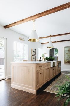 a kitchen with wood floors and white walls