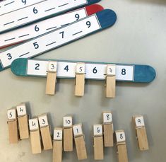 wooden pegs are arranged in the shape of numbers on a table with magnets attached to them