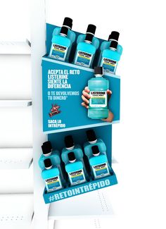 a shelf with several bottles of hand sanitizer on it and an ad for refintedio