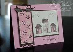 a handmade card with a house on the front and a bow at the back