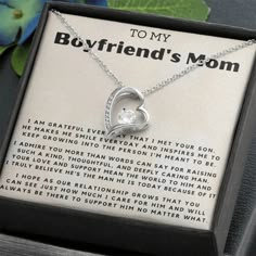 a necklace with a heart on it in a box