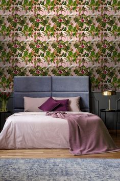 a bedroom with floral wallpaper and purple bedding