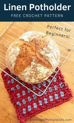 a loaf of bread sitting on top of a red and blue knitted dishcloth