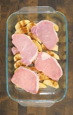 ham and potatoes in a glass dish on a wooden table