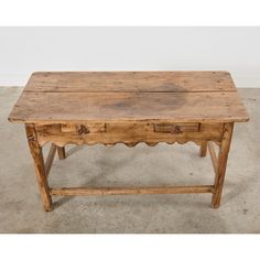 an old wooden table with two drawers on one side and a drawer on the other