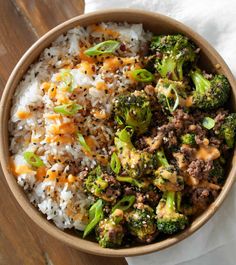 a bowl filled with rice, broccoli and ground beef