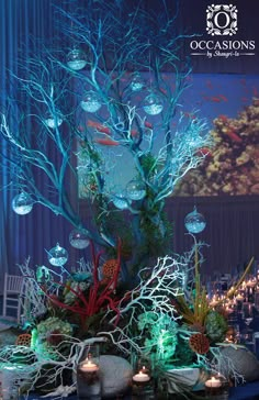 the centerpiece is made out of branches and rocks, with lit candles on each side