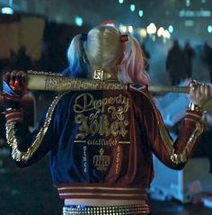 a woman with pink hair holding a baseball bat in her hand and wearing a jacket that says property is sold