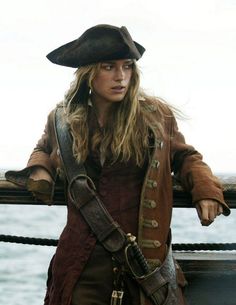 a woman with long hair wearing a pirate hat and holding onto a barbwire