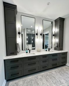 a large bathroom with double sinks and mirrors