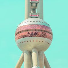 a very tall tower with a clock on it's side and a sky background