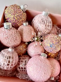 pink and gold ornaments are in a box