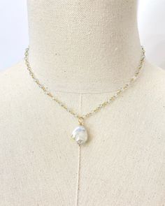 This elegant Baroque Pearl and Aquamarine Necklace is a luxurious statement piece featuring a large baroque pearl suspended on a chain of shimmering micro-faceted pale blue aquamarine gemstone beads, all handcrafted with beautiful gold fill. This coastal-inspired necklace is perfect for adding an elegant touch to any look, either solo or layered with other pieces. Necklace length: 16 inches plus 2 inch extender Materials: baroque pearl, aquamarine gemstone beads, gold filled clasp, wire and comp Briolette Pearl Jewelry With Natural Stones, Baroque Pearl Pendant Long Necklace, White Baroque Pearl Jewelry With Gemstone, Baroque Pearl Teardrop Jewelry With Pearl Chain, Baroque Pearl Briolette Jewelry For Gifts, Gold Baroque Pearl Necklace With Gemstone, Teardrop Baroque Pearl Chain Jewelry, Pearl Teardrop Gemstone Necklaces, Teardrop Pearl Gemstone Necklaces