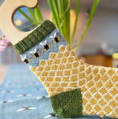 a pair of socks with holes in them sitting on a table next to a plant