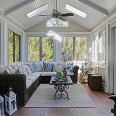 a living room filled with furniture and lots of windows