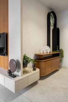 a living room with white walls and wooden furniture