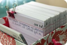 a close up of a bunch of papers in a box with clipboards stuck to it