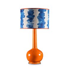 an orange table lamp with a blue and white lampshade on the base,