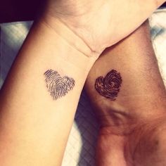 two people with matching tattoos on their arms