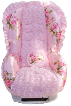 a pink baby seat with flowers on it's back and the front facing up