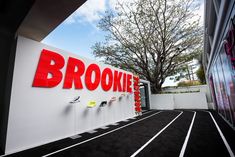 a sign that says brooke on the side of a building next to a race track