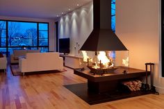 a living room filled with furniture and a fire place in front of a large window