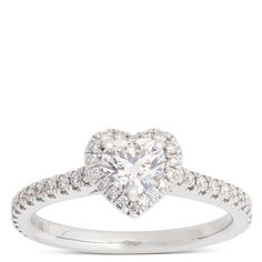 a heart shaped diamond ring with diamonds on the band and an open halo setting in white gold