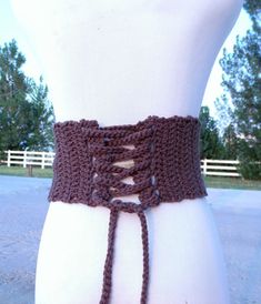 a crocheted belt is shown on top of a mannequin's torso