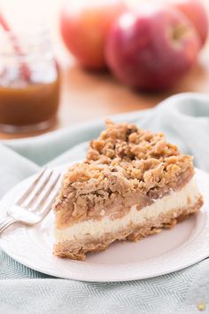 a slice of apple crisp cheesecake on a white plate