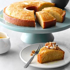 a cake on a plate with a fork next to it and two slices cut from the cake