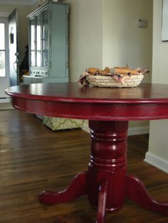 a red table with a basket on top