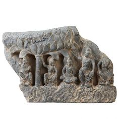 an ancient sculpture with people and animals on it's side, against a white background