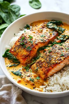 salmon and rice in a white bowl with spinach