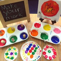 some paper plates with paint on them sitting on a table