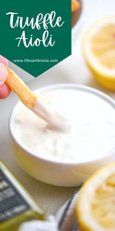 a person dipping some food into a bowl with lemons around it and the words, truffe aloii above them