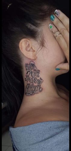 a woman with tattoos on her neck and behind her ear