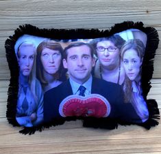 a pillow with a photo of the cast of tv show friends on it sitting on a wooden surface