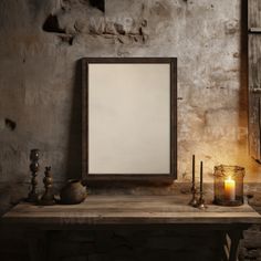 an old table with candles and a frame on it